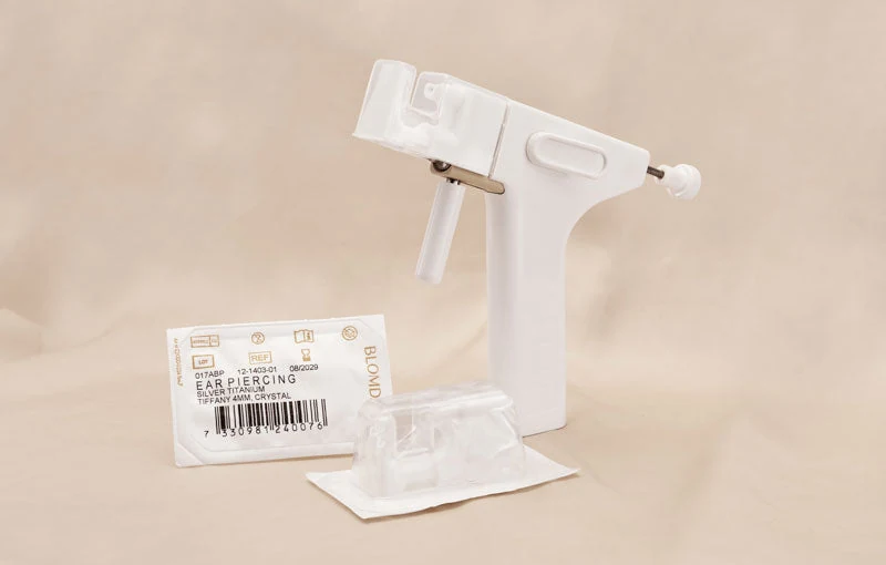 BLOMDAHL ear piercing instrument with packaged piercing jewellery